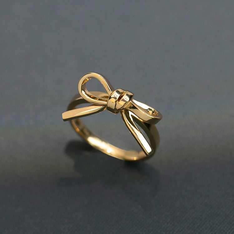 lose-up view of a stylish 925 Sterling Silver Bow Tie Ring worn on the index finger, showcasing a fashionable and elegant accessory for women.