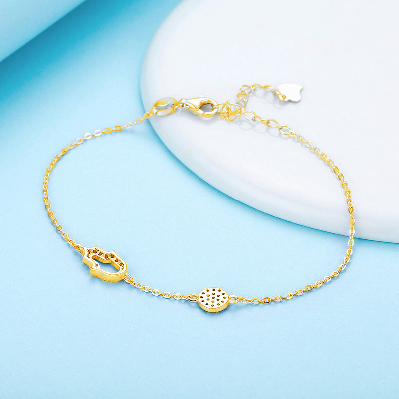 Sterling silver bracelet featuring a Blue Evil Eye Hamsa Hand charm adorned with Cubic Zirconia accents for a stylish and protective accessory