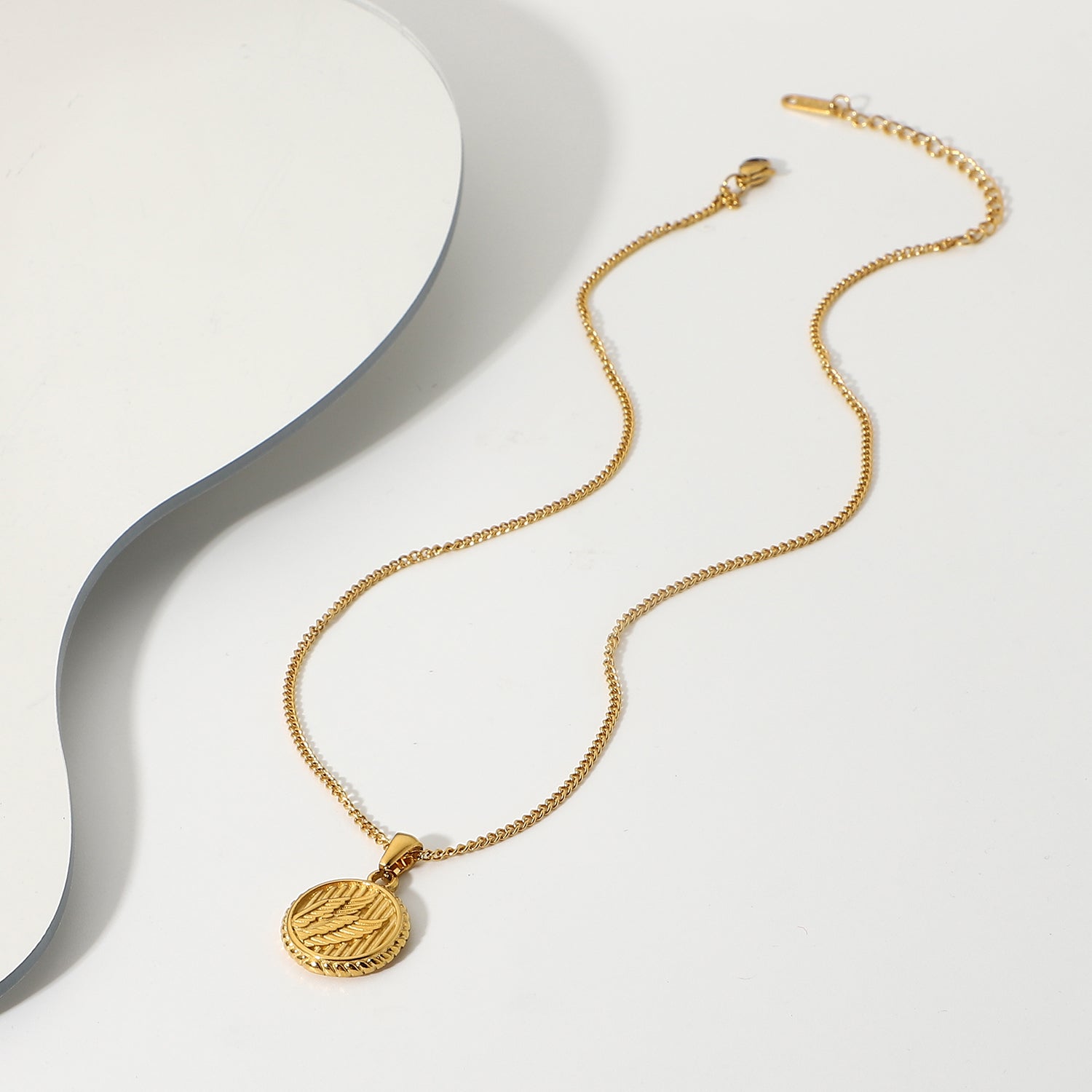 Simple necklace with three dimensional wings round coin pendant