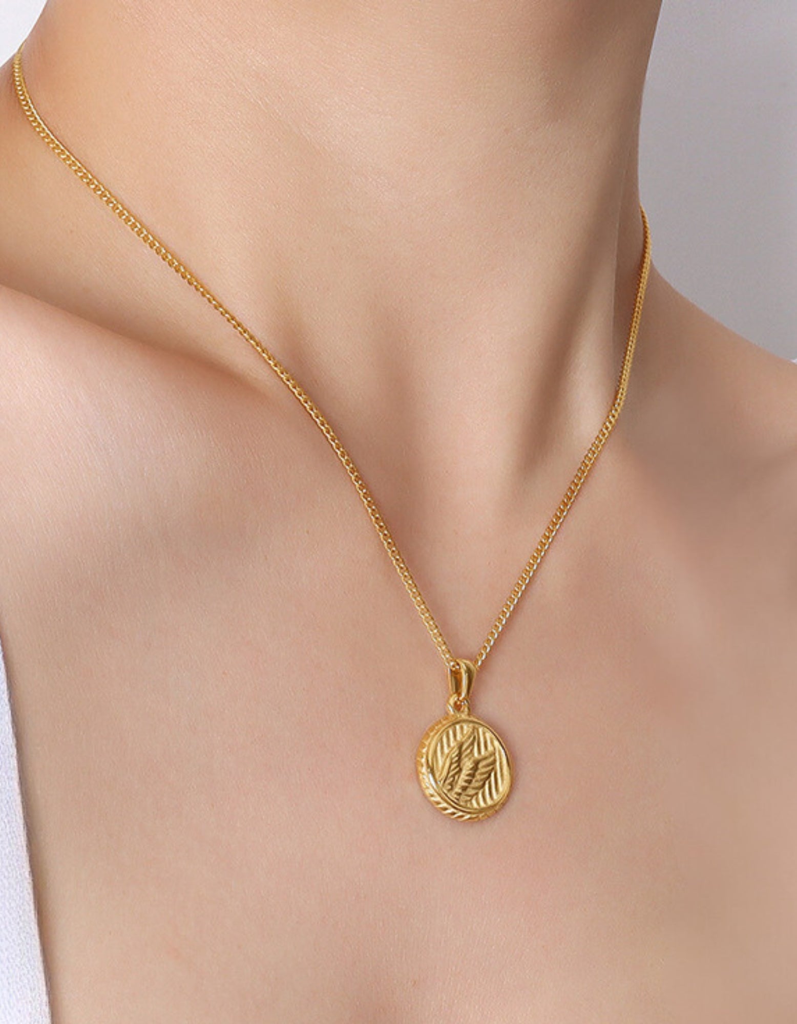 Simple necklace with three dimensional wings round coin pendant
