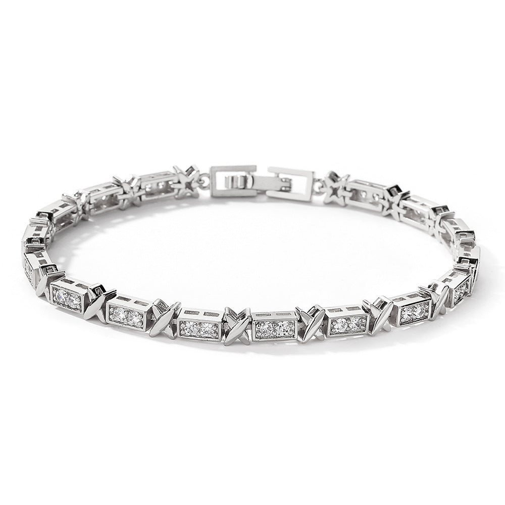 Silver bracelet with diamond accents on a white background