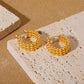 Simple gold stud earrings on model — PURAJOIA