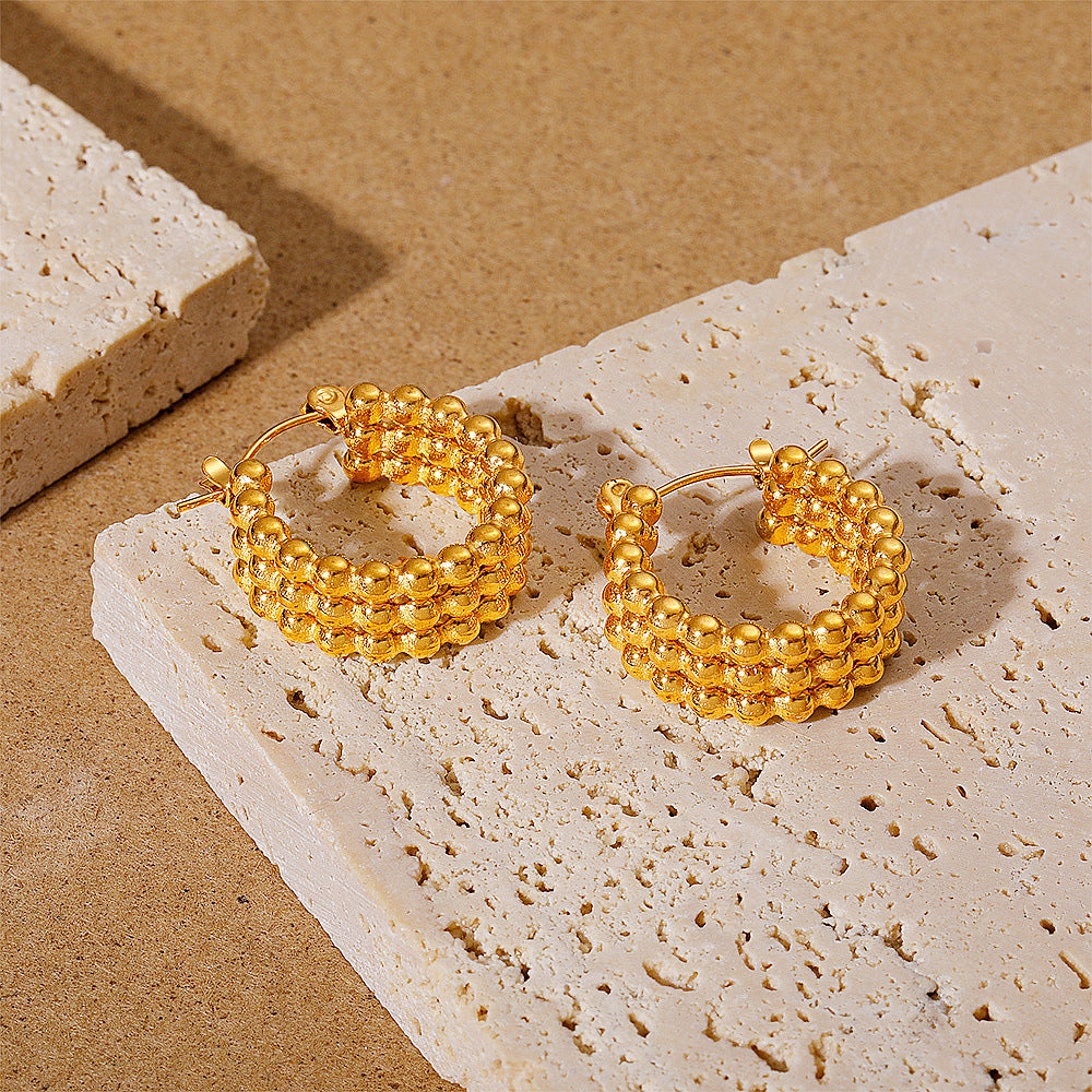 Simple gold stud earrings on model — PURAJOIA