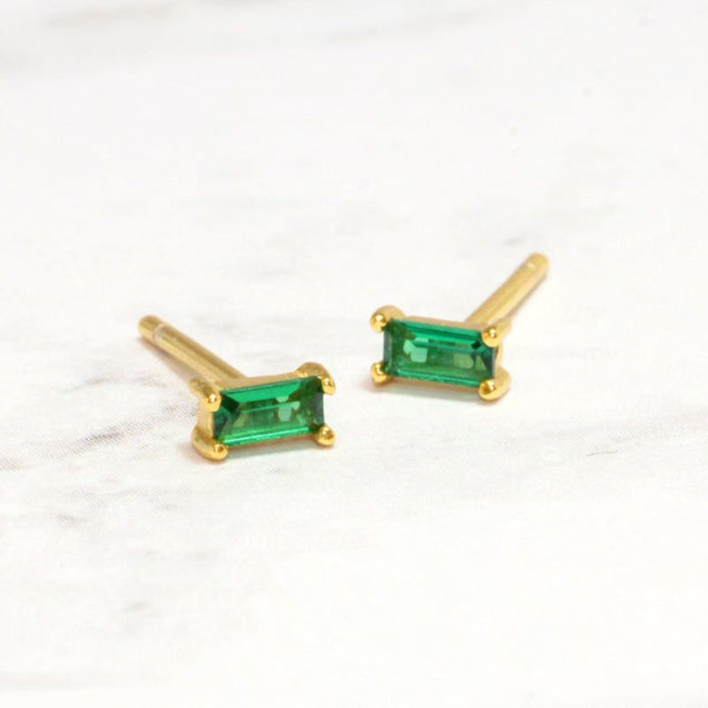 Sterling silver stud earrings featuring square green gems, adding a touch of elegance and vibrancy to your accessory collection.