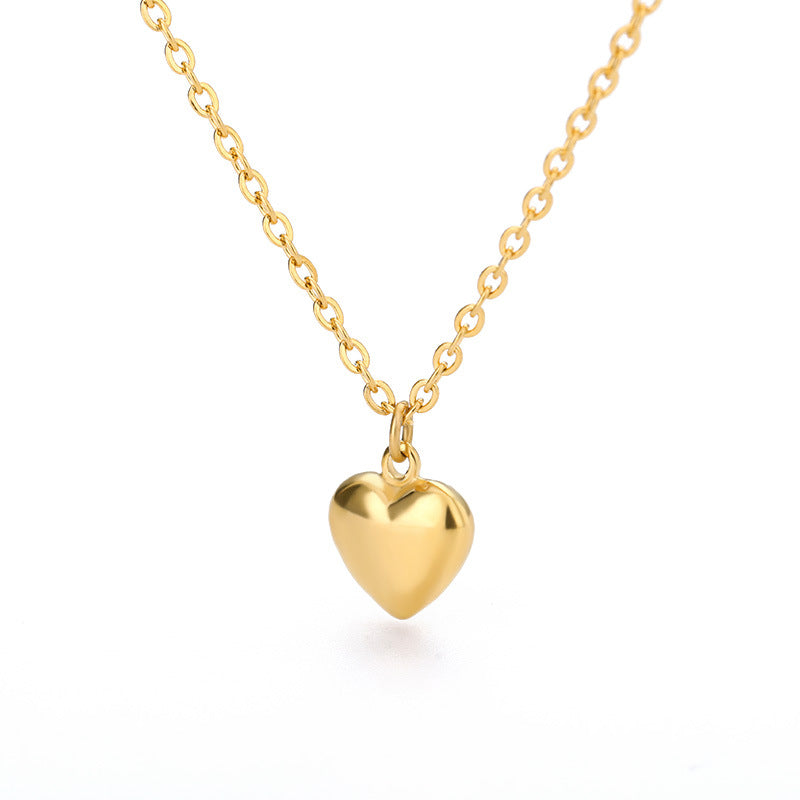 Close-up of a stylish Gold Plated 18k Stainless Steel Choker with a heart pendant, showcasing timeless elegance and modern glamour.