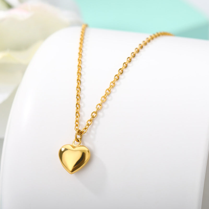 Close-up of a stylish Gold Plated 18k Stainless Steel Choker with a heart pendant, showcasing timeless elegance and modern glamour.