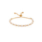 Pearl and gold bracelet on woman's wrist — PURAJOIA