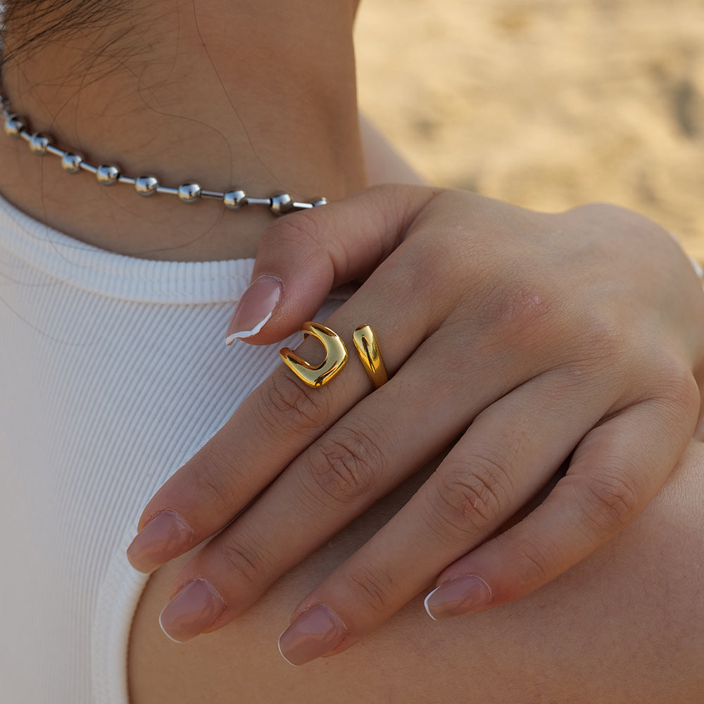 Stainless steel adjustable rings with gold plating, minimalist design.