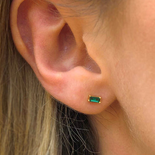 Sterling silver stud earrings featuring square green gems, adding a touch of elegance and vibrancy to your accessory collection.