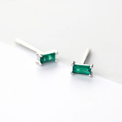 Sterling silver stud earrings featuring square green gems, adding a touch of elegance and vibrancy to your accessory collection.