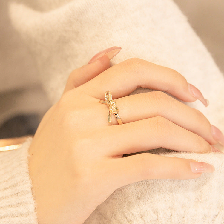 lose-up view of a stylish 925 Sterling Silver Bow Tie Ring worn on the index finger, showcasing a fashionable and elegant accessory for women.