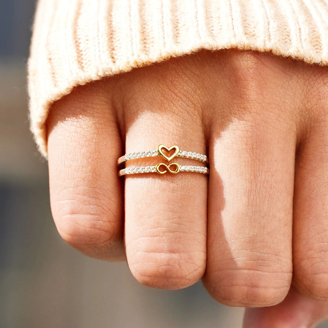 Handmade Silver Two-color Heart Infinity Ring displayed on a graceful hand, showcasing intricate craftsmanship and timeless elegance.