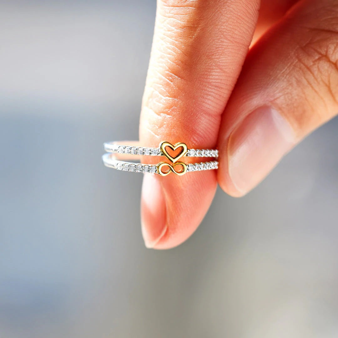 Handmade Silver Two-color Heart Infinity Ring displayed on a graceful hand, showcasing intricate craftsmanship and timeless elegance.