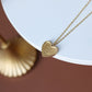 Gold stainless steel heart necklace on a delicate chain, showcasing timeless elegance and durability in a sophisticated accessory.