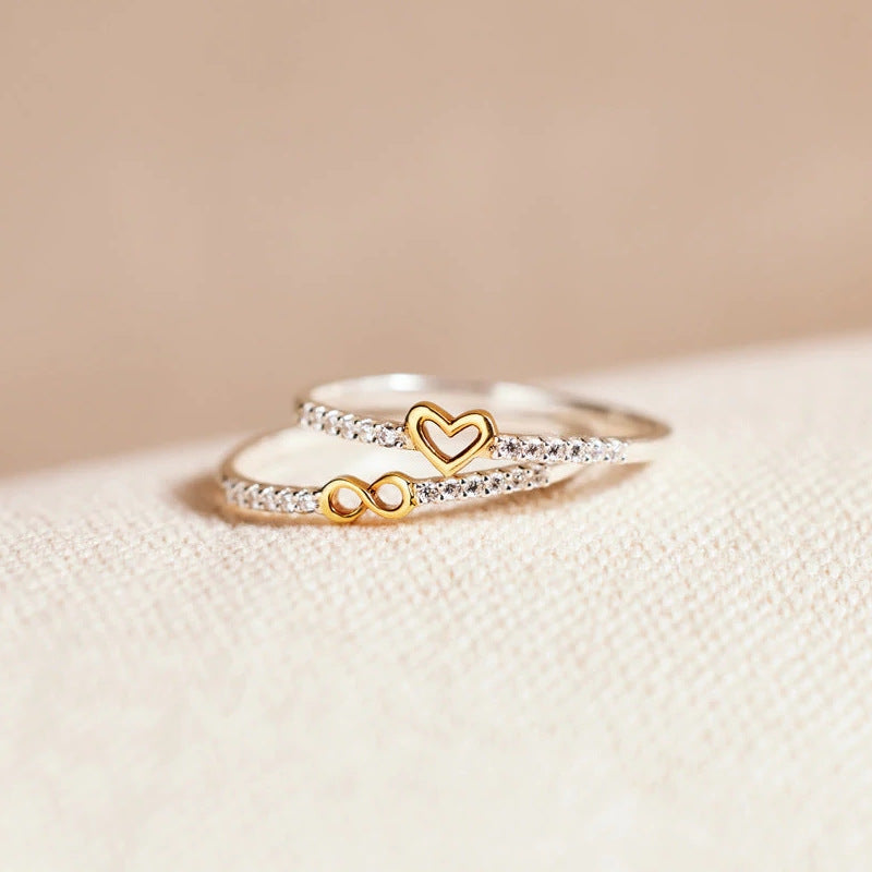 Handmade Silver Two-color Heart Infinity Ring displayed on a graceful hand, showcasing intricate craftsmanship and timeless elegance.