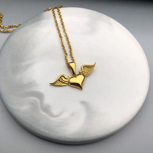 Chic Heart Shape With Wings Necklace: A fusion of stainless steel and gold-plated elegance, perfect for adding a touch of grace to your ensemble.