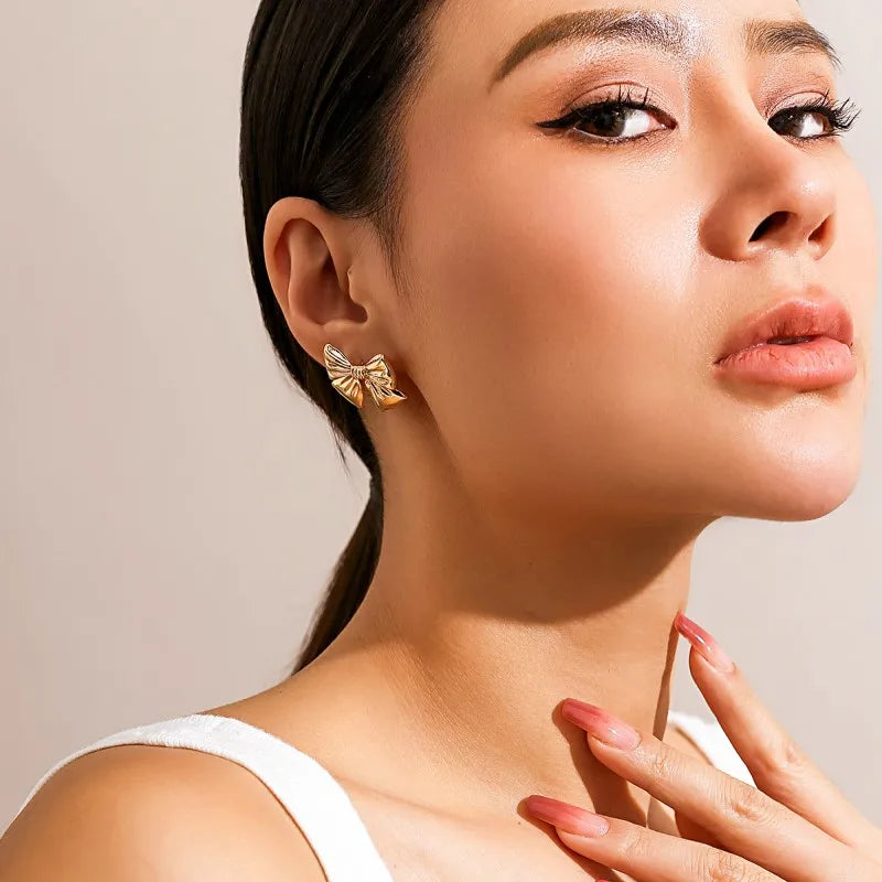 Close-up view of Vintage Gold Bow Earrings on a white background, showcasing intricate design and timeless elegance for women's fashion.