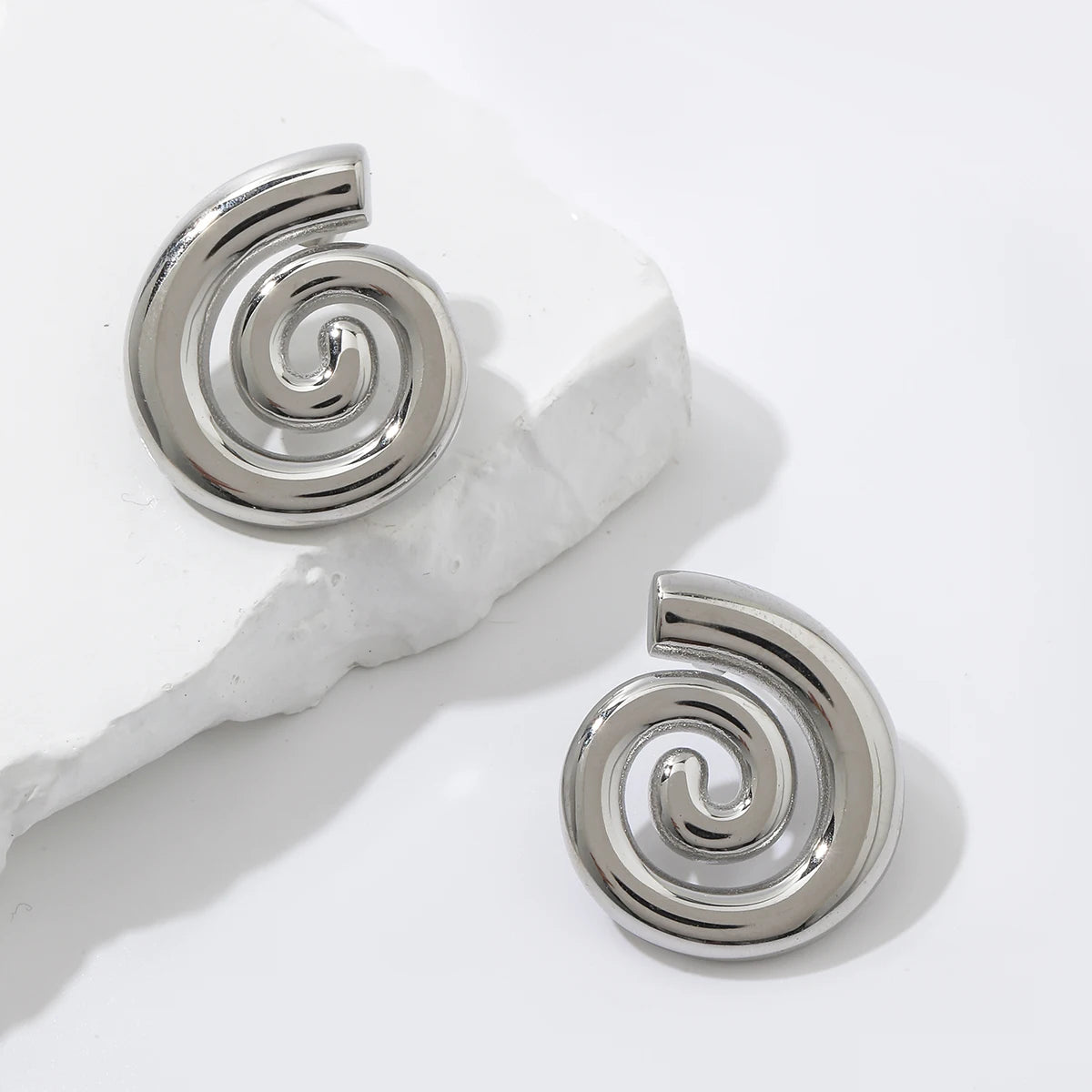 Stylish and minimalist 18K gold-plated geometric spiral stud earrings crafted from durable stainless steel, adding a touch of modern elegance to your ensemble.