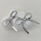 Stylish stainless steel flat snake chain earrings featuring an elegant ribbon bow design for women's fashion