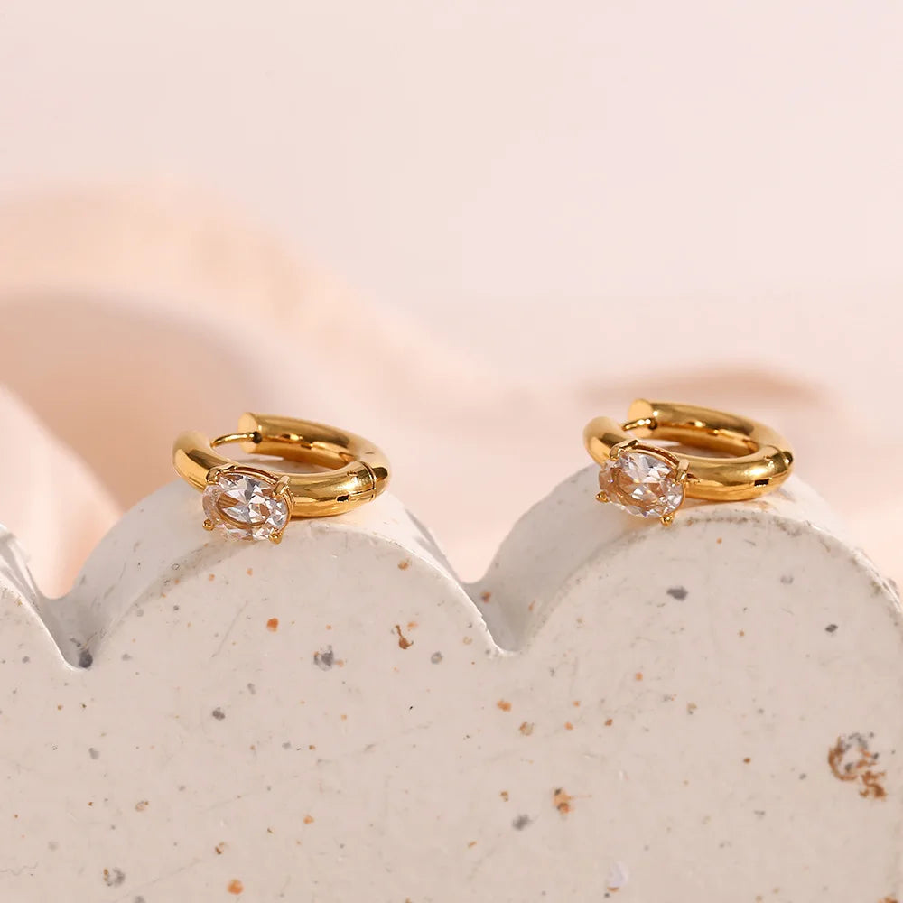 Close-up view of Stainless Steel Thick Oval Zircon Earrings, showcasing an elegant 18K gold-plated circle hoop design for a radiant and sophisticated accessory.