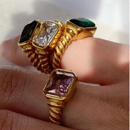 Stainless steel twisted spiral ring with rectangular emerald pink zircon, a captivating and elegant accessory for timeless style.