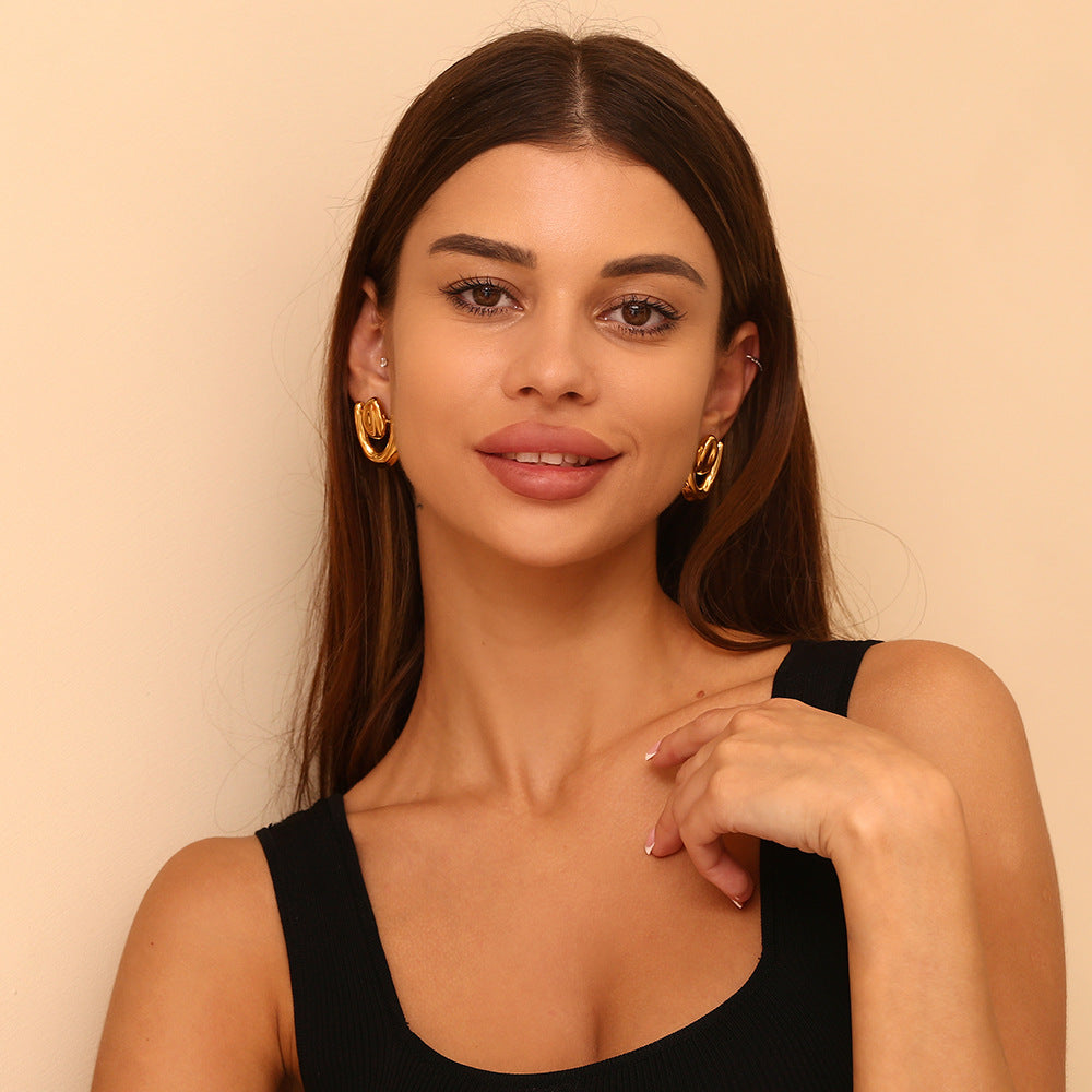 Close-up detail of Amora irregular heart stud earrings