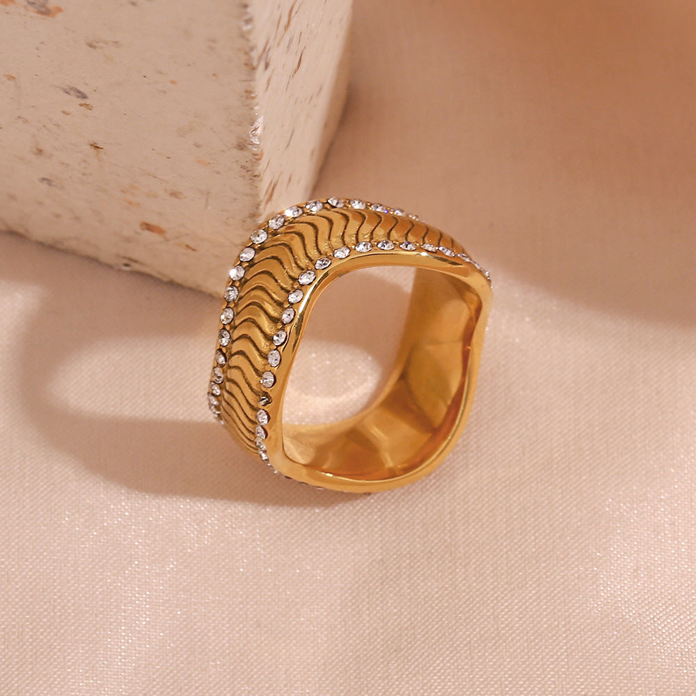 Stainless Steel 18k Plated Ring showcasing a wavy twill design and dual stone embellishments, radiating elegance and sophistication