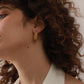 Simple gold stud earrings on model — PURAJOIA