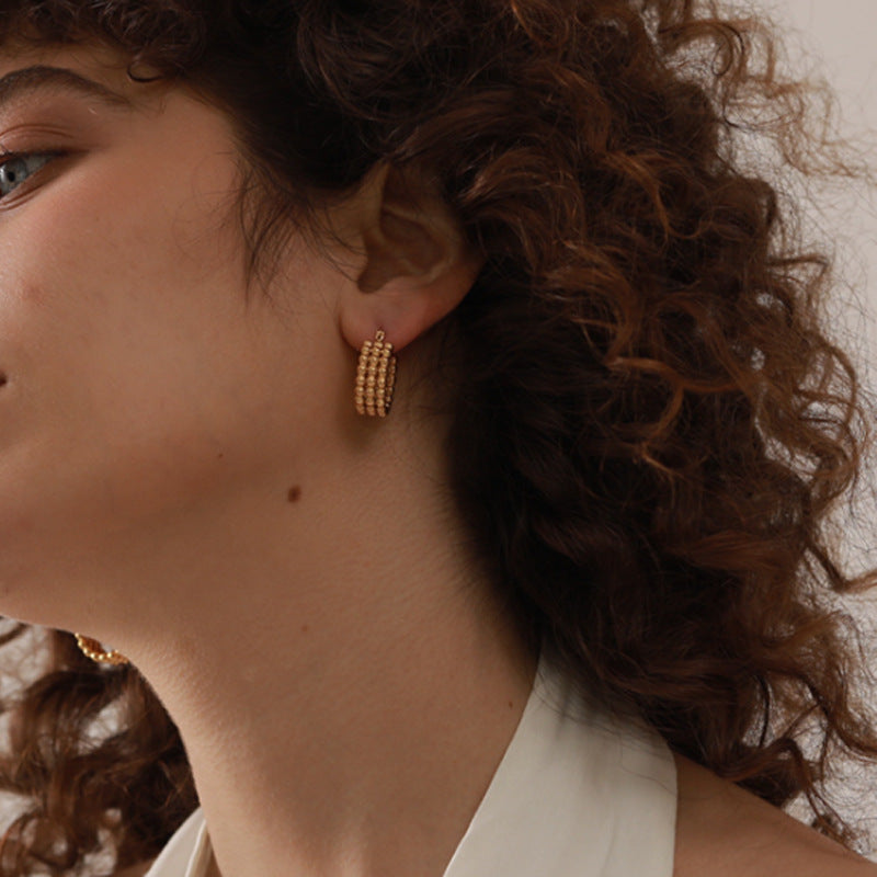 Simple gold stud earrings on model — PURAJOIA
