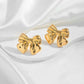 Close-up view of Vintage Gold Bow Earrings on a white background, showcasing intricate design and timeless elegance for women's fashion.