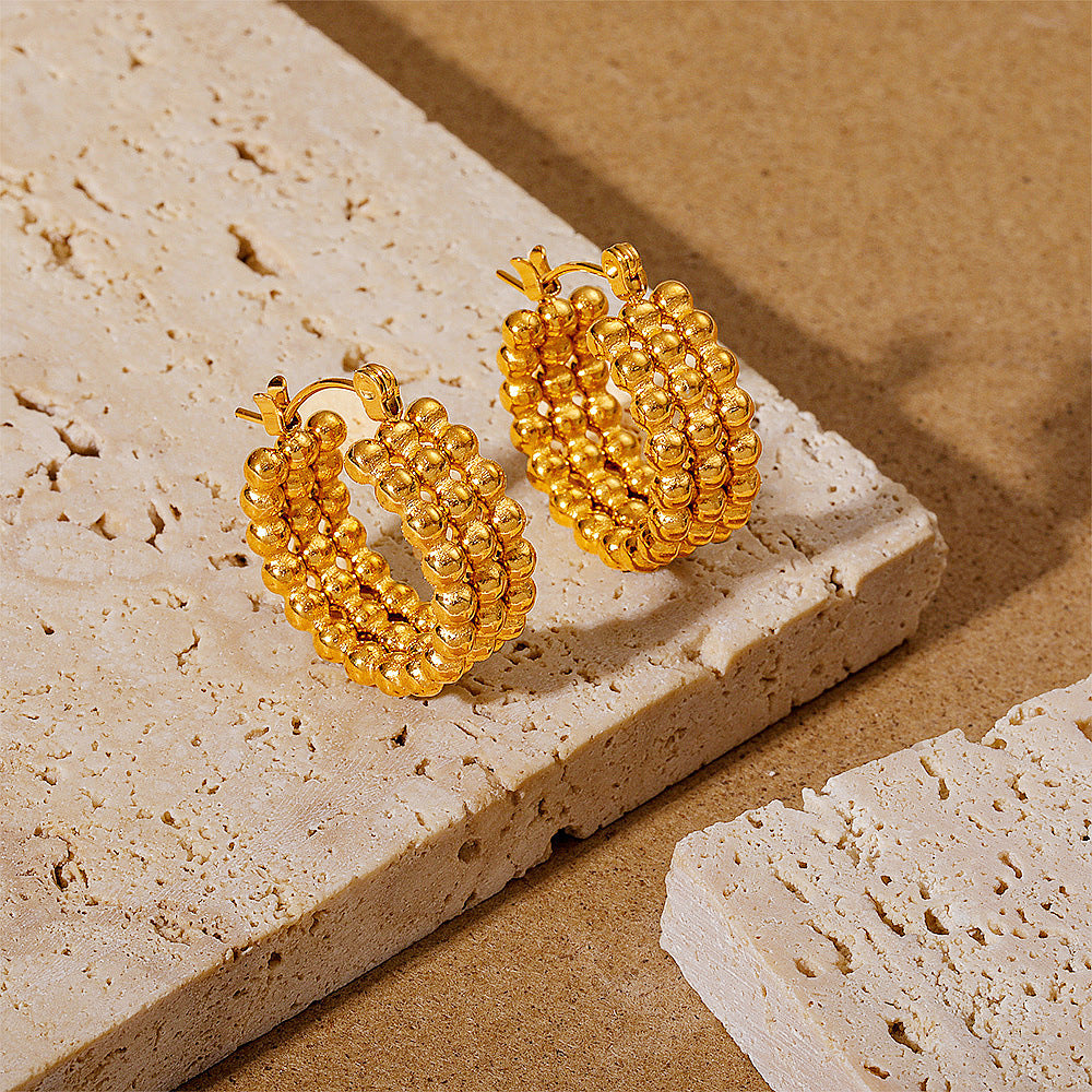 Simple gold stud earrings on model — PURAJOIA
