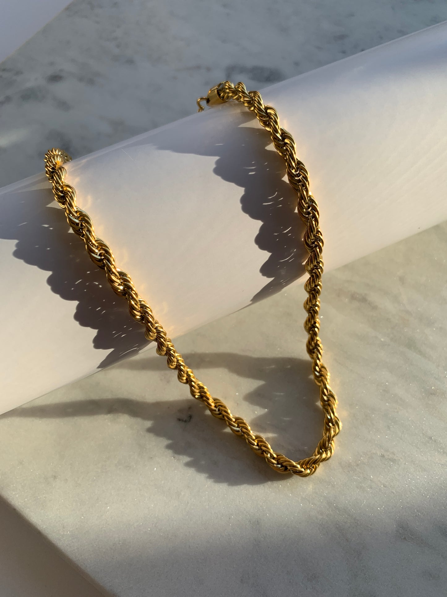 Add a unique touch to your outfit with our Twisted Chain Necklace, crafted from high-quality stainless steel and 18K gold plating for a lasting shine