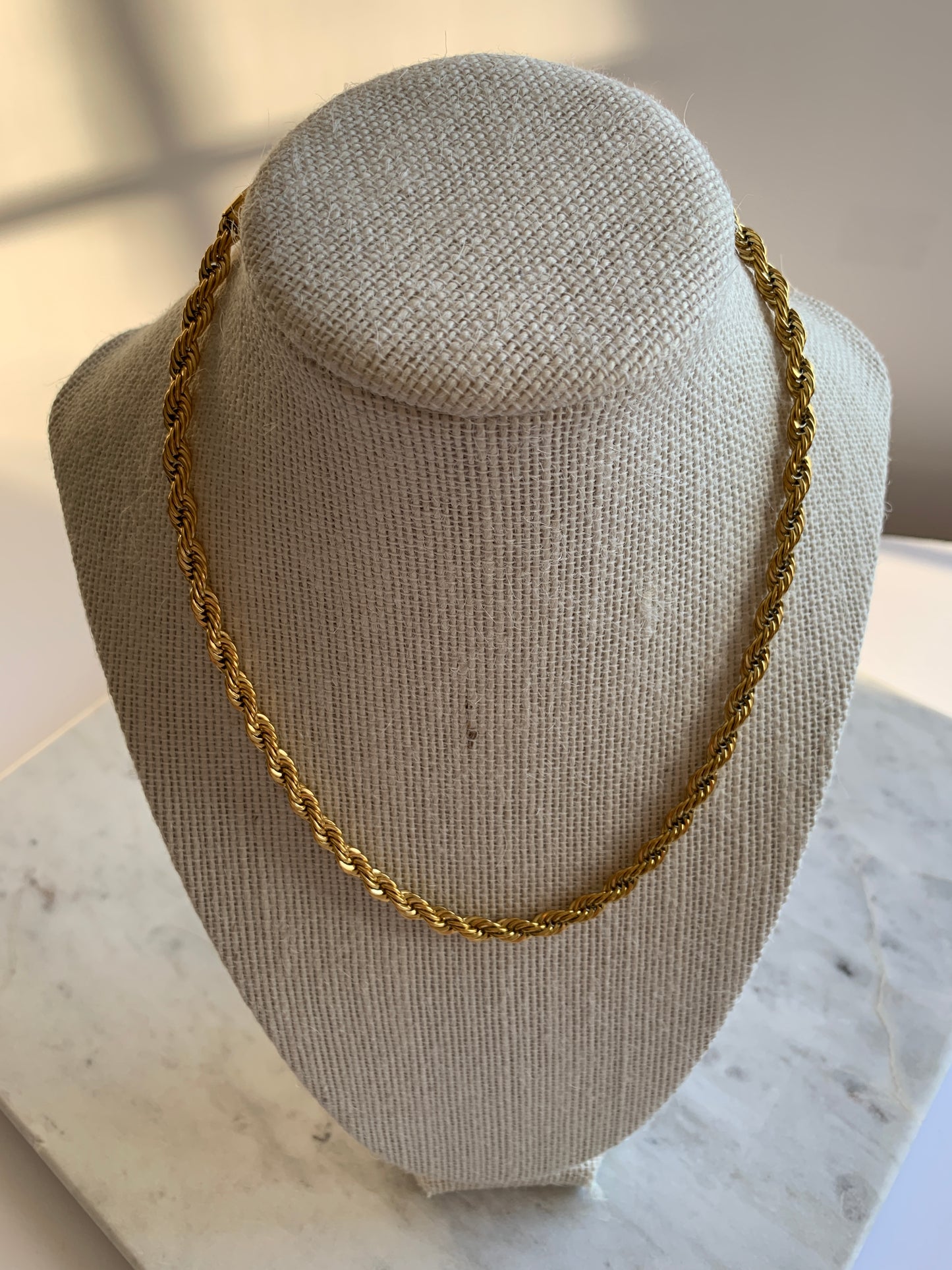 Add a unique touch to your outfit with our Twisted Chain Necklace, crafted from high-quality stainless steel and 18K gold plating for a lasting shine