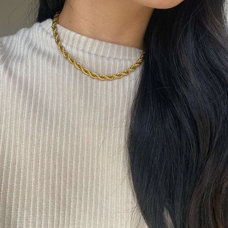 Add a unique touch to your outfit with our Twisted Chain Necklace, crafted from high-quality stainless steel and 18K gold plating for a lasting shine